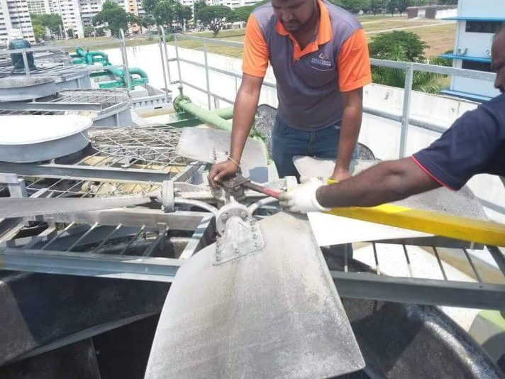 HVAC cooling tower fan repair and maintenance on rooftop unit in Singapore